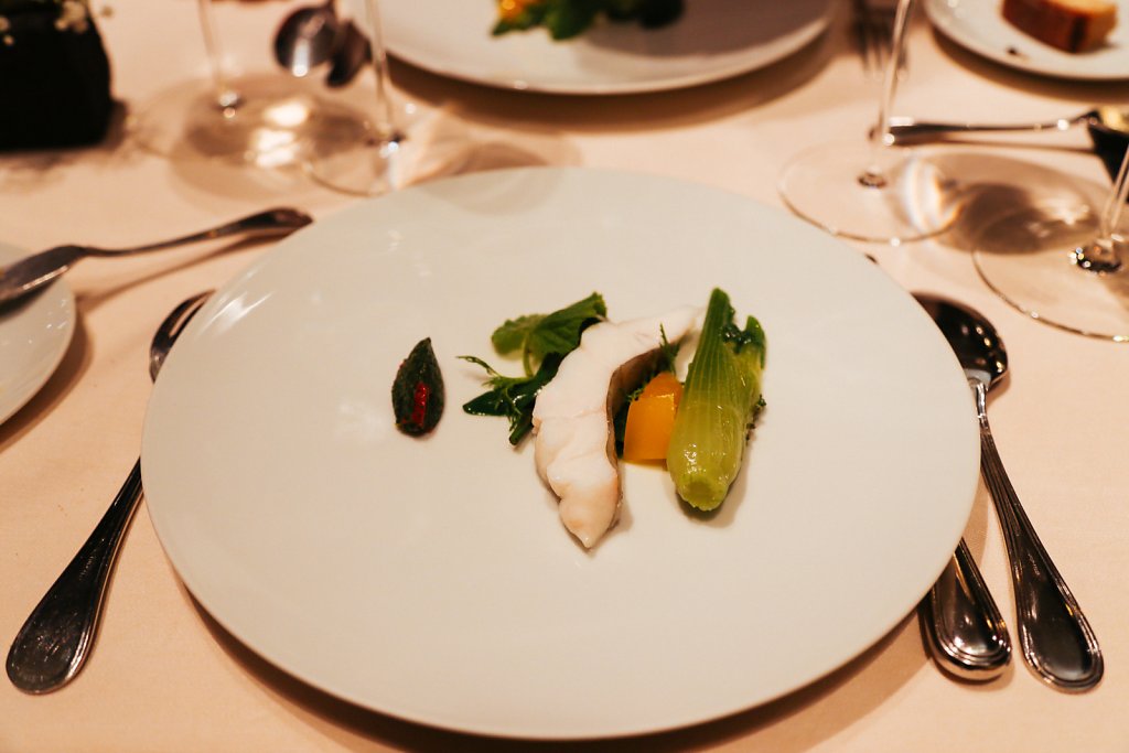 Steamed John Dory with steamed vegetables, heated yuzu, julienned zest of yuzu, a salty herb and powdered cumin