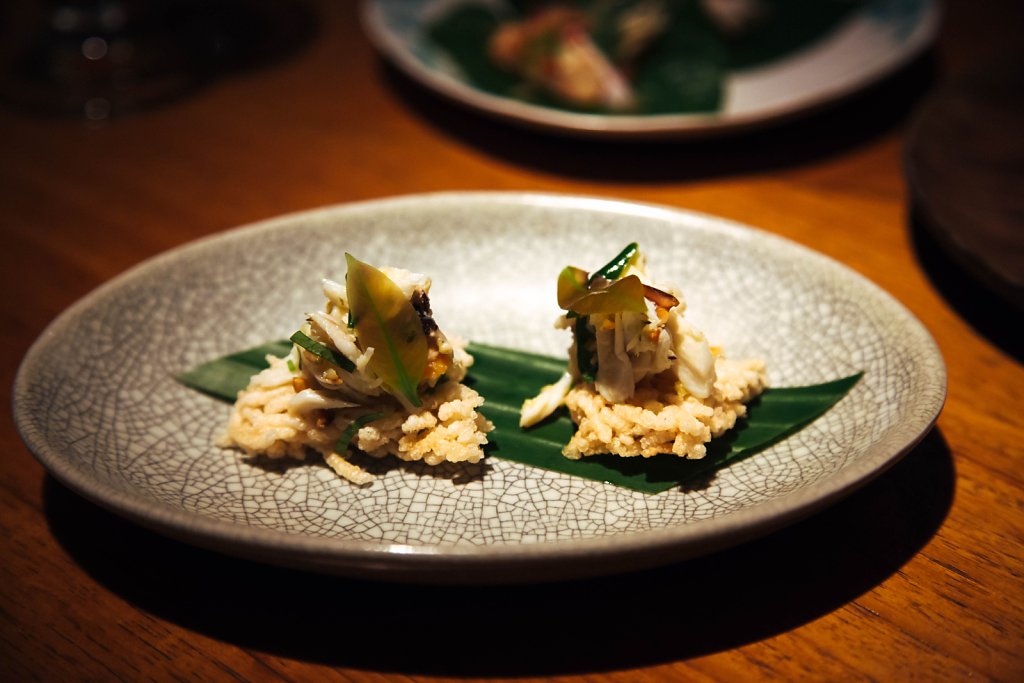 Blue swimmer crab with peanuts and pickled garlic on rice cakes
